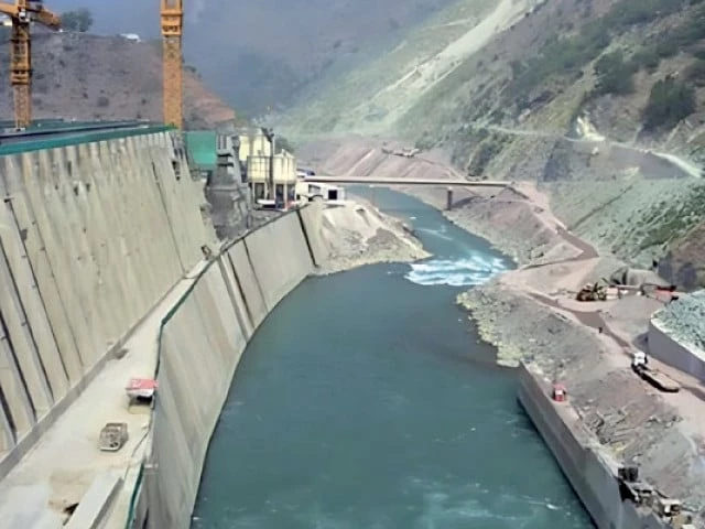 Dam construction works in a river gorge with tower cranes, illustrating the Mohmand Dam cost increase