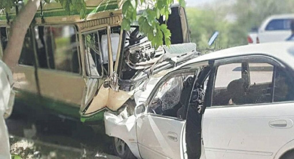A wrecked passenger coach and car after a head-on Sanghar collision, file photograph