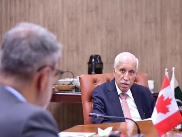 Pakistani and Canadian officials in talks beneath both flags on the bilateral investment treaty