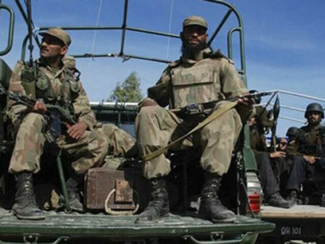 Soldiers on a military vehicle, file photograph, illustrating a report on a DI Khan operation