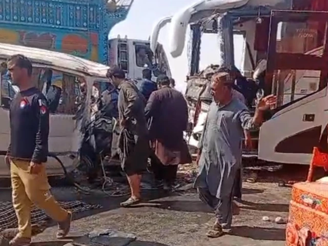 Rescue workers and police at the wreckage of the Uthal bus collision in Lasbela, Balochistan